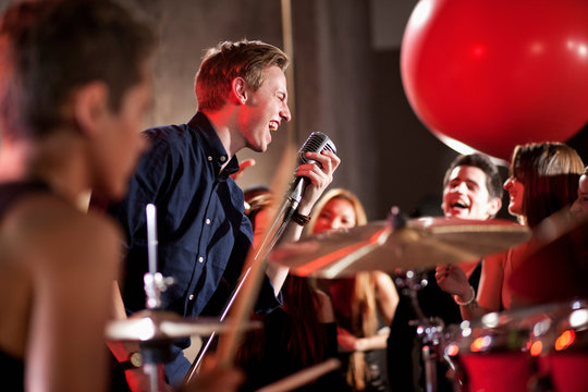 Young man singing in band