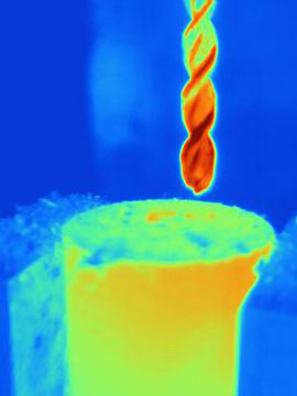 Thermal image of drilling into a component, showing the heat bulidup on the drill bit and the part