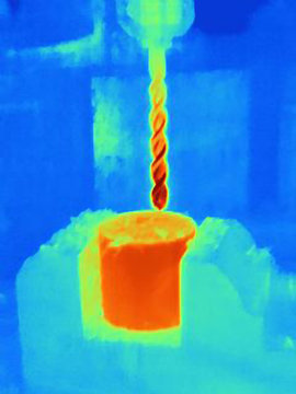 Thermal image of drilling into a component, showing the heat bulidup on the drill bit and the part