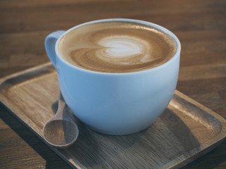 Latte coffee on wooden tray