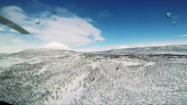 Winter landscape in Sweden with forests and mountains - shot from helicopter