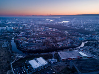 Fototapeta premium View of the industrial quarter of the city at sunset