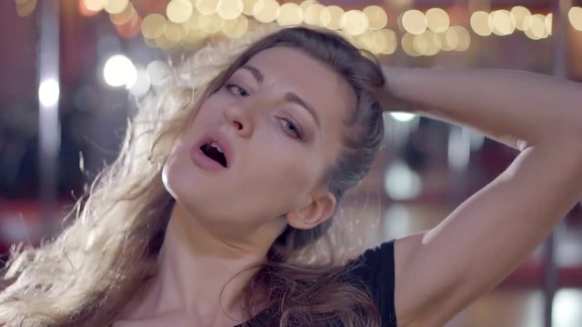 Beautiful happy woman dancing in the night