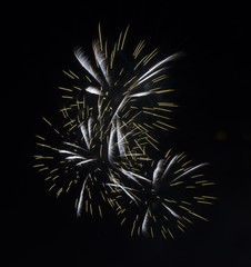 Triple fireworks burst on dark background