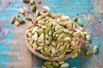 Raw Organic Cardamom Pods on wooden background ready to use