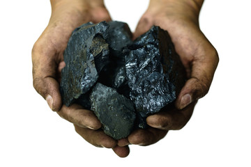 Selective focus of coal in worker's hands isolated on the white background, energy concept