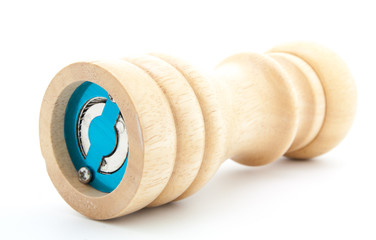 pepper mill of wood with peppercorns