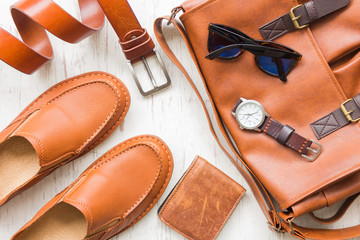 Men's leather accessories on white rustic wooden background