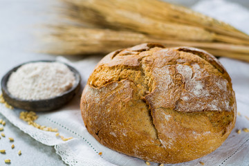 Freshly baked traditional wheat bread and wheat ears