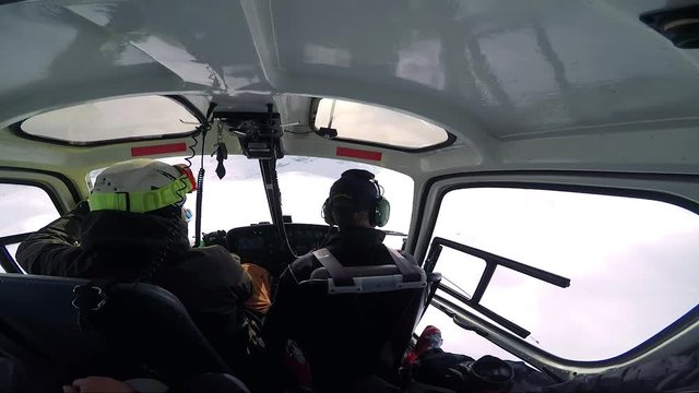 Man skier flies in helicopter as a passenger in winter - first person view