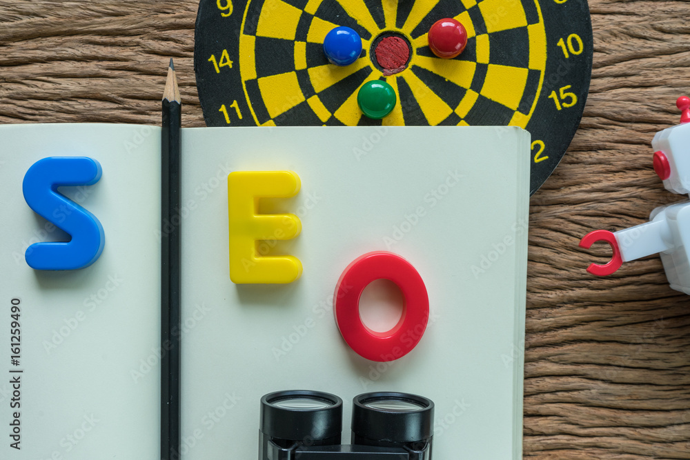 Poster seo search engine optimization concept with pencil, alphabets seo on paper note, dartboard, robot an