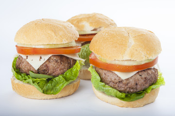 Giant homemade burger classic american cheeseburger isolated on white