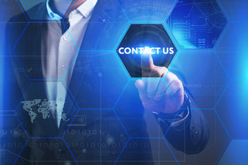Business, Technology, Internet and network concept. Young businessman working on a virtual screen of the future and sees the inscription: Contact us