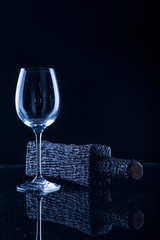 Wine bottle with a glass on a black background