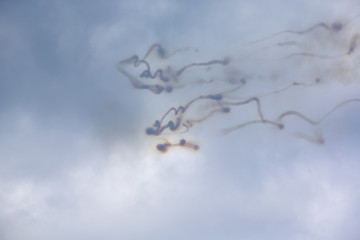 Writing on the sky. Smoke trails from jet fighters on a cloudy sky. Abstract and decorative.