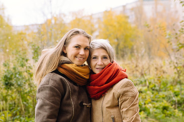 Fototapeta premium Happy mother and daughter portrait. Portrait of beautiful mature mother and her daughter . 