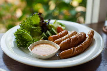 Close-up of grilled sausages on a white plate,  Selective focus.