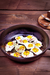 Fried quail eggs in a black frying pan