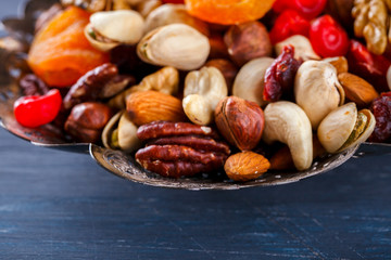 Nuts and dried fruit mix. Concept of Healthy Food. Vintage wooden background. Copy space for Text. selective focus