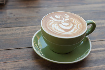 Cup of hot coffee latte with beautiful style on wood table