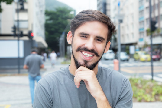 Laughing hispanic guy with beard