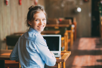 Successful businesswoman using wi-fi in cafe