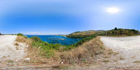 Fish farm in the sea. View from mountain. Floating fish farm and breeding fry in trays grids. 360 degree spherical panorama from Corfu island (Kerkyra). Sidari region. Greece