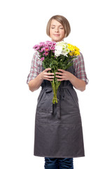 smiling attractive woman professional florist, gardener or botanist enjoying various flowers smell isolated on white background. floristry service and business concept. flower shop advertising