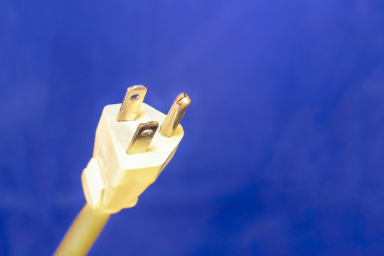 White Electrical Plug and Cord on Blue Background