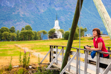 Tourist relaxing on bridge in village Oppstryn Norway