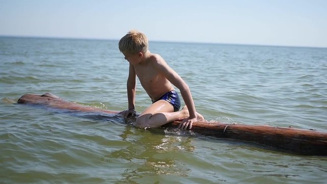 A happy child swims in the sea. Fun and games outdoors