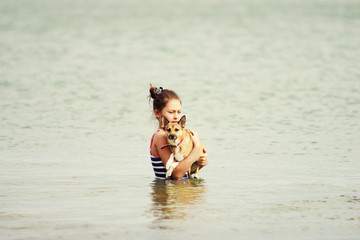 Child and dog in the sea