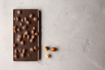 Chocolate bar with nuts on table