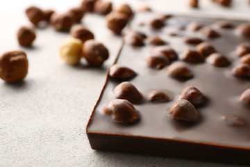 Chocolate bar with nuts on table