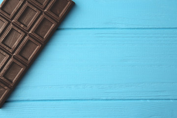 Chocolate bar on blue table