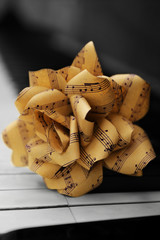 Fototapeta premium Rose made of music notes on piano keys