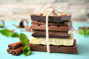 Tied chocolate pieces with mint on table