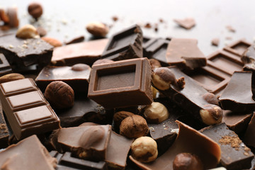 Heap of broken chocolate pieces on table