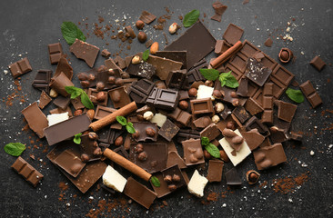 Heap of broken chocolate pieces on table