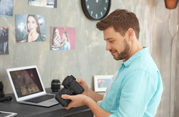 Young photographer looking at picture on camera display