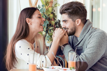 Young couple eating lunch at restaurant