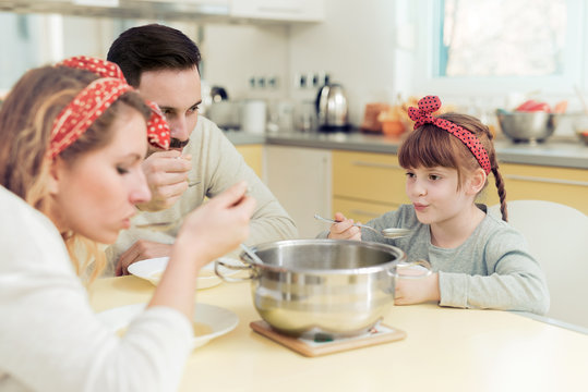 Family Eating Soup At Home