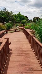 Obraz premium wooden walk way with landscape of garden