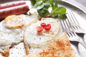 Delicious breakfast with over hard eggs, closeup
