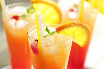 Glasses of Tequila Sunrise cocktail with orange slices, closeup