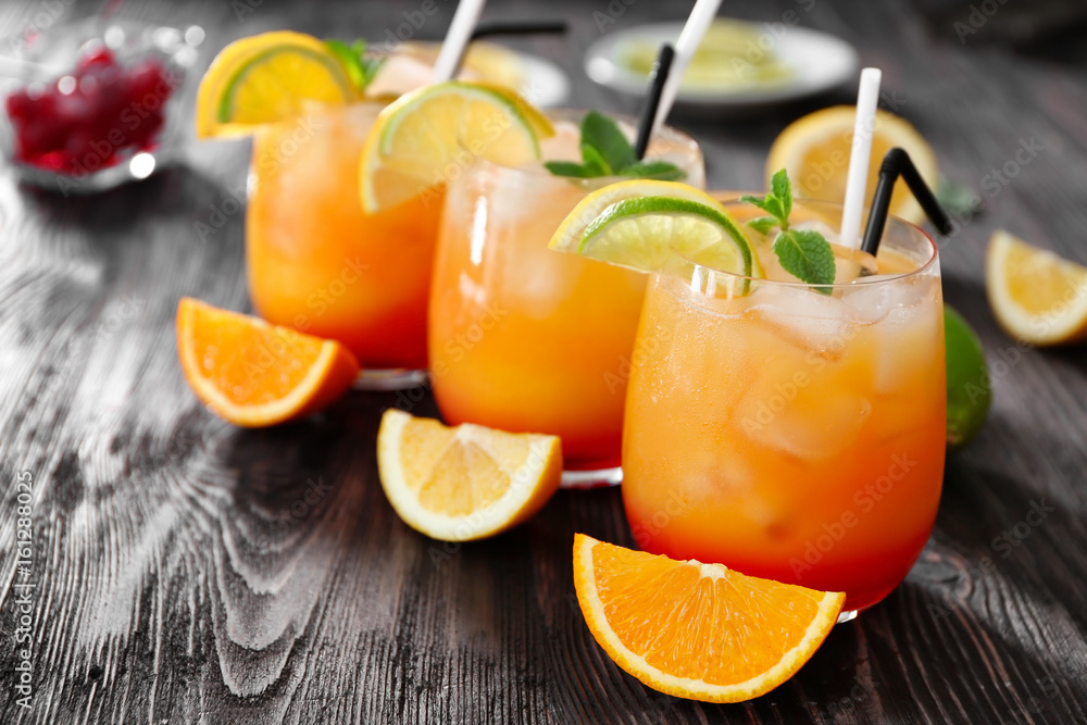 Poster Glasses of Tequila Sunrise cocktail on wooden table