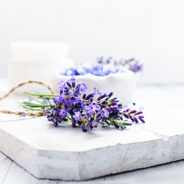 ingredients for lavender spa, flower and salt on white wooden background.