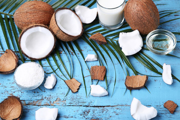 Coconuts with leafs on blue wooden table