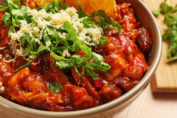 Bowl with delicious chili turkey on table, closeup