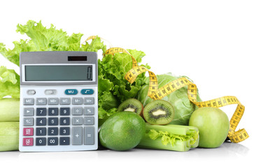 Weight loss concept. Fresh vegetables, fruits, calculator and measuring tape on white background